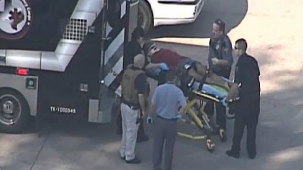 College shooting ... an injured male a put into an ambulance.