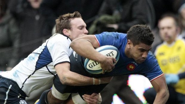Wesley Fofana of France crashes over for a try despite the tackle of Mike Blair.