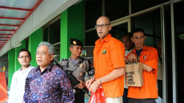 Neil Bantleman and Ferdinant Tjiong leaving the police station to be transferred to prison. 