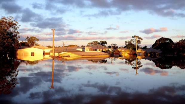 The sun rises over flooded streets as parts of southern Queensland experiences record flooding in the wake of Tropical Cyclone Oswald.