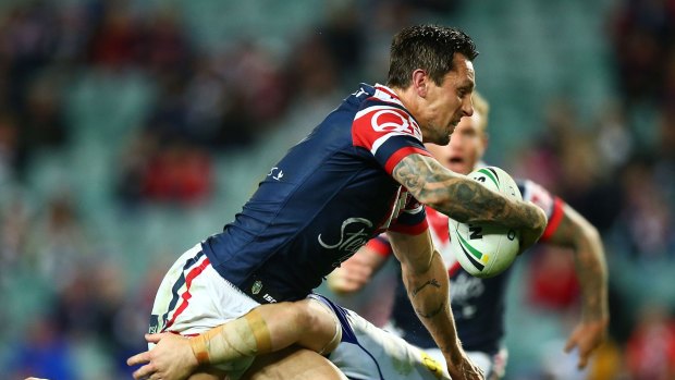 Throwing himself into the game: Mitchell Pearce shows plenty of commitment against the Bulldogs.