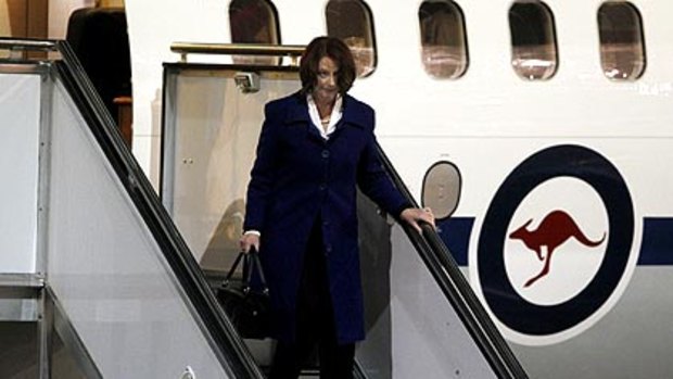 Julia Gillard returns to Canberra from Queensland to finalise a deal with mining executives.