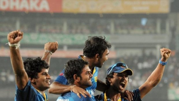Sri Lankan cricketers Dinesh Chandimal (R) and Lahiru Thirimanne (2L) carry teammate Mahela Jayawardena.