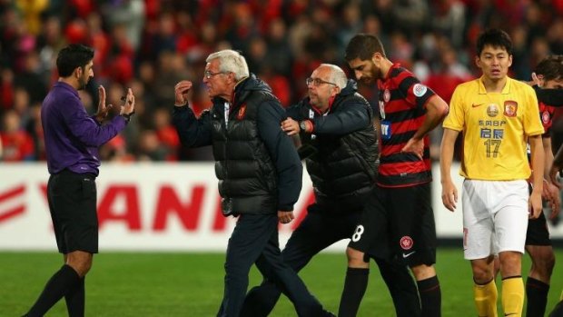 Spite night: The Wanderers' quarter-final first leg was marred by red cards and a pitch invasion by Guangzhou coach Marcello Lippi.