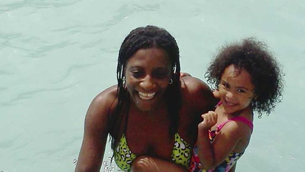 Marie Joseph holds family friend Dalianys Melendez in the public swimming pool in Fall River, Massachusetts. Ms Joseph's body was later found in the pool two days after she drowned.