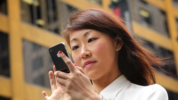 Mai Lin with her mobile phone.