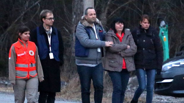  A woman (second from right) believed to be a relative of a deceased crew member on Germanwings flight 4U9525 is comforted at a reception centre in Le Vernet, France.