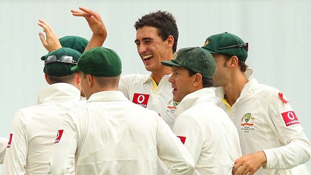 Debutant Mitchell Starc celebrates after taking the wicket of New Zealand's Jesse Ryder at the Gabba yesterday. He also snared the Kiwi captain, Ross Taylor.