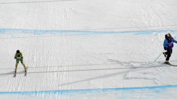 Close call ... Australia's Craig Branch narrowly misses a worker on the track during his downhill run in Whistler this week.