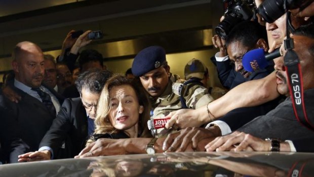 Valerie Trierweiler, former partner of French President Francois Hollande, is escorted by security after her arrival in Mumbai.