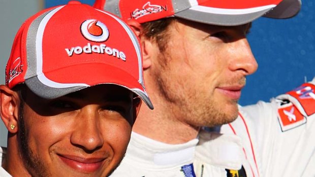 Lewis Hamilton, left, and Jenson Button celebrate yesterday after ensuring an all-British front row for today's Australian Grand Prix in Melbourne.