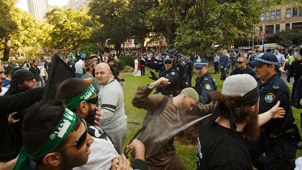 Running battles ... protesters, furious at a US film denigrating the prophet Muhammad clash with police on the streets of Sydney yesterday.