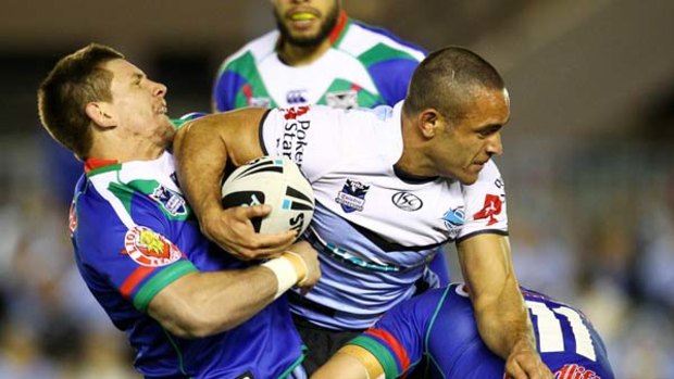 Paul Aiton of the Sharks is tackled.