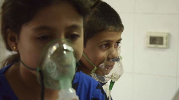 Children, affected by what activists say was a gas attack, breathe through oxygen masks in the Damascus suburb of Saqba.