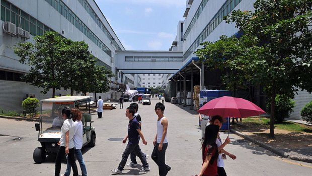 Workers walk between buildings at a giant Foxconn plant at Shenzen, in southern China.