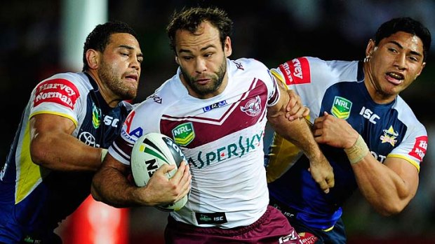 Brett Stewart of the Sea Eagles is tackled by by Antonio Winterstein and Jason Taumalolo of the Cowboys.
