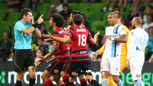 Ref justice: Wanderers players confront referee Jarred Gillett after he ruled that they took a free-kick too quickly to score against Melbourne City.