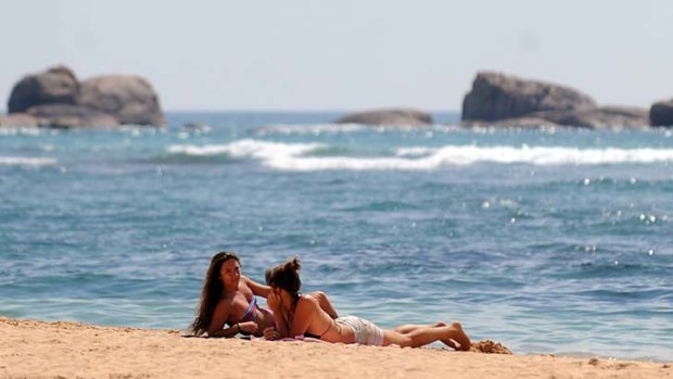 Hot spot ... tourists take a rest on the beach of Sri Lanka's southern coastal town of Hikkaduwa.