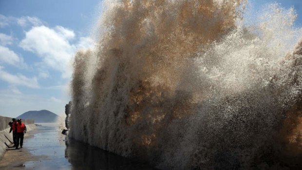 Waves surge up against the Diaobin fishing port in Wenling city, as eastern China braced for torrential downpours from Typhoon Soulik.