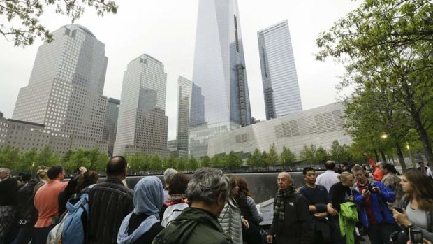 Expressions of loss: Visitors at the September 11 Memorial, which opened this week.
