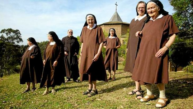 A formidable brown line: Discalced Carmelite nuns and Father Greg Burke at their Varroville monastery.