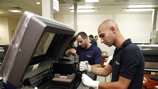 Technicians work on the assembly of 3D printing machines at the Stratasys factory in Rehovot, Israel.