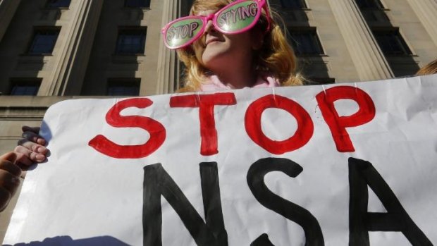 Anti-spying protesters gather outside the US Department of Justice in Washington, DC.