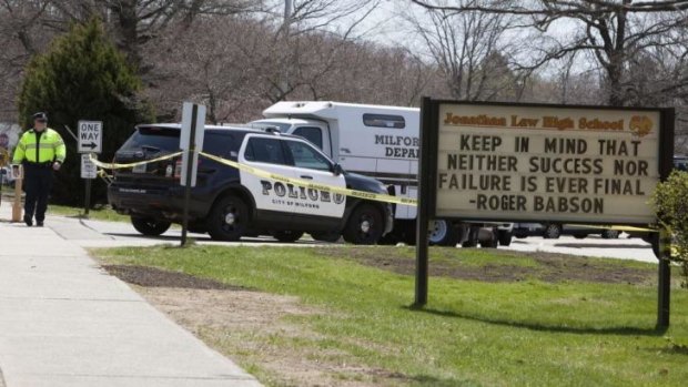 Police guard the front of Jonathan Law High School in Milford, Connecticut after a 16-year-old girl was killed by a fellow schoolmate.