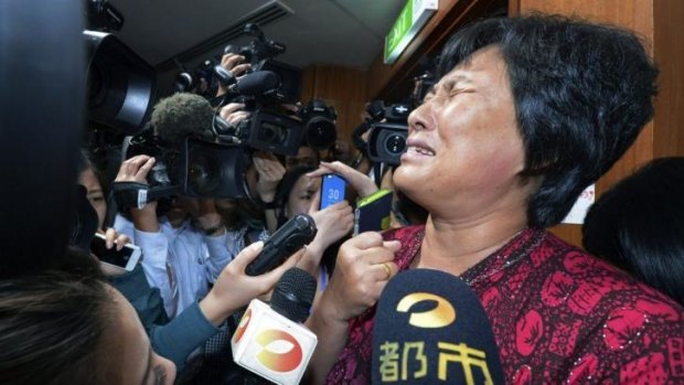 A Chinese relative of passengers aboard a missing Malaysia Airlines plane cries as she speaks to journalists at a hotel in Sepang, Malaysia.