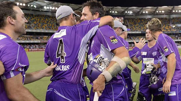 Ben Hilfenhaus of the Hobart Hurricanes is embraced by his teammates after taking his team to victory over the Brisbane Heat.