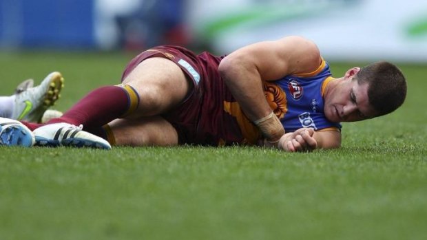 Jonathan Brown lies on the ground injured during the round 17 game against the Cats in 2011.