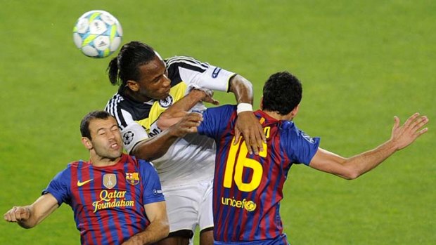 Chelsea's Ivorian forward Didier Drogba (centre) vies with Barcelona's midfielder Sergio Busquets (right) and Barcelona's Argentinian midfielder Javier Mascherano during the UEFA Champions League second leg semi-final football match in Barcelona.