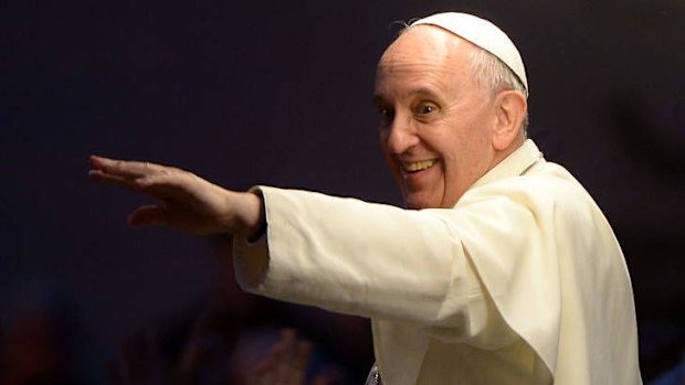 Pope Francis greets the crowd as he leaves the basilica of Saint Mary of the Angels in Assisi.