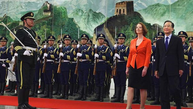 Dialogue... the Prime Minister, Julia Gillard, and the Chinese Premier, Wen Jiabao, view an honour guard during a welcoming ceremony in Beijing yesterday.