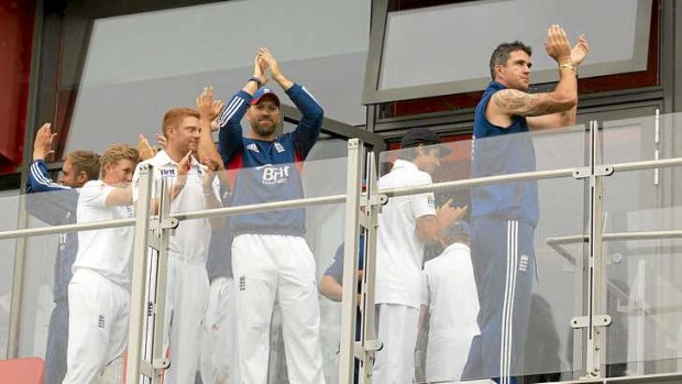 Cursory celebration: England players (from R) Kevin Pietersen, and Matt Prior after play is abandoned.