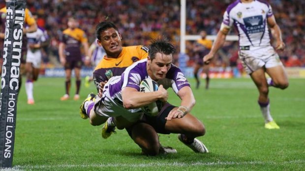 Damage done: Melbourne Storm's Cooper Cronk crosss for a try against the Broncos.