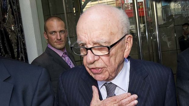 Hand on my heart ... Rupert Murdoch leaves the London hotel where he met Milly Dowler's family.