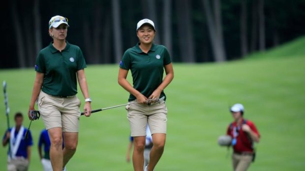 Karrie Webb (left) and Minjee Lee walk to the 4th green during round one of the  International Crown