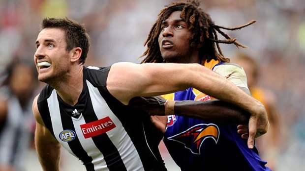 Opposing styles: Magpie ruckman Darren Jolly has problems with the leaping style of the Eagles' Nic Naitanui.