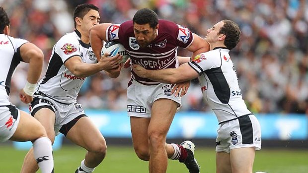 Brent Kite of the Sea Eagles drives the ball through the middle of theWarriors defence.