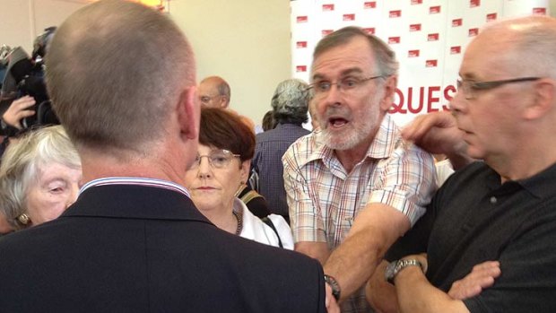 A man angrily confronts LNP leader Campbell Newman after fiery community forum in Ashgrove.