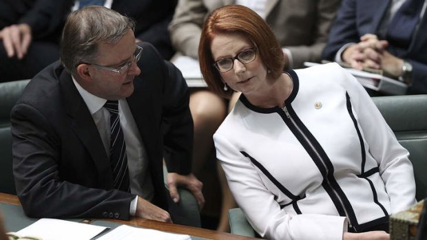 Prime Minister Julia Gillard speaks with Anthony Albanese during question time.