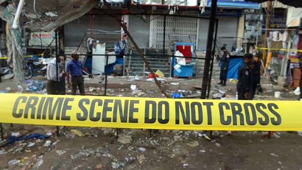 Indian police search for clues at one of the blast sites  in Hyderabad. The police have admitted that they knew Hyderabad was a potential target.
