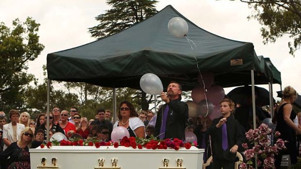 Survivor ... John Tyson releases a balloon at the funeral of his wife Donna Rice and son Jordan.