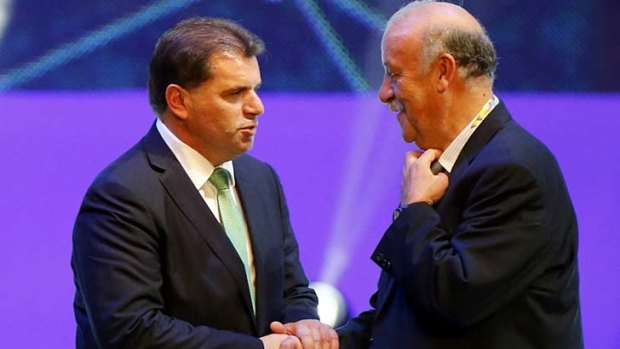 Ange Postecoglou speaks with Spain's coach Vicente del Bosque after the draw.