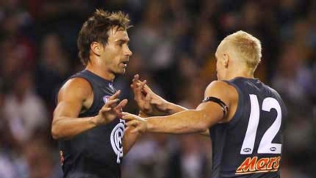 Andrew Walker celebrates a goal with Mitch Robinson in the game against Richmond.