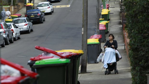 Bins line the street after Transpacific pulled its trucks off the road for safety reasons. 