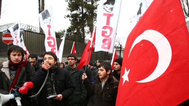 Turkish students hold Turkish flags as they stage a protest outside the French Embassy in Ankara.