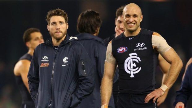 Dale Thomas and Chris Judd of the Blues look dejected after the narrow loss.
