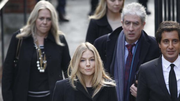 British actress Sienna Miller, center, arrives to testify at the Leveson inquiry at the Royal Courts of Justice in central London.